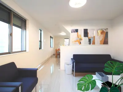 a living room with two blue couches and a plant at New building Shinjuku area town house in Tokyo
