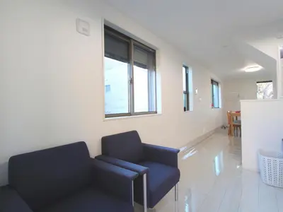 a living room with a couch and a window at New building Shinjuku area town house in Tokyo