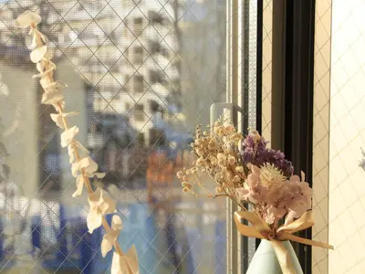 a vase filled with flowers sitting in a window at New building Shinjuku area town house in Tokyo