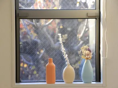 three vases sitting on a window sill with flowers at New building Shinjuku area town house in Tokyo