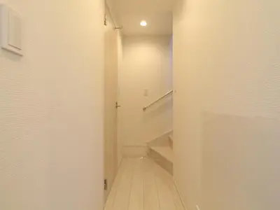 a hallway with white walls and wooden floors and stairs at New building Shinjuku area town house in Tokyo