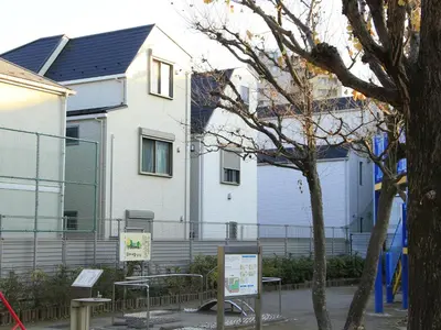 a white building with a fence in front of it at New building Shinjuku area town house in Tokyo