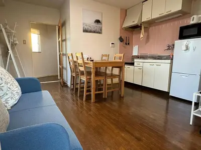 a kitchen with a table and chairs in a room at Sun white Gyoutoku 301 in Tokyo