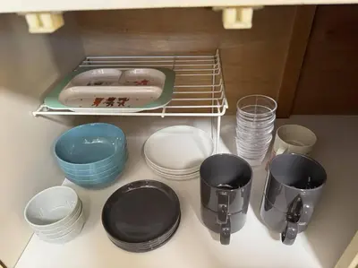 a shelf with bowls and plates and a hot dog on it at Sun white Gyoutoku 301 in Tokyo