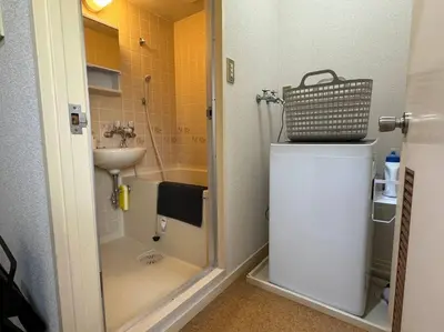 a small bathroom with a shower and a sink at Sun white Gyoutoku 301 in Tokyo