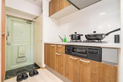 a kitchen with wooden cabinets and a stove at Ikebukuro East Exit, 2BR in Tokyo