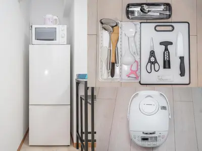 a kitchen counter with a white refrigerator and utensils at Ikebukuro East Exit, 2BR in Tokyo