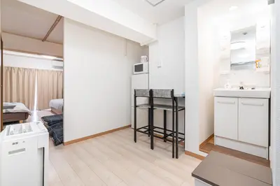 a kitchen and a living room with a sink and a refrigerator at Ikebukuro East Exit, 2BR in Tokyo