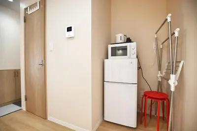 a white refrigerator with a microwave on top of it at QU201 Edogawa Japanese Style Apartment 201 has direct access to Akihabara and Shinjuku, with convenient transportation and free WiFi in Tokyo