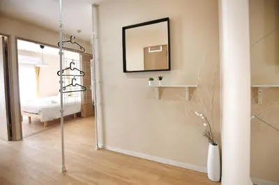 a hallway with a mirror and a room with a bed at QU201 Edogawa Japanese Style Apartment 201 has direct access to Akihabara and Shinjuku, with convenient transportation and free WiFi in Tokyo