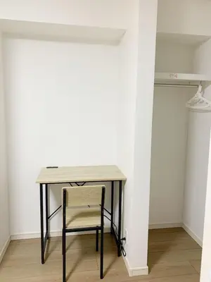 a table with a chair next to a white wall at Shinjuku新宿近新建公&干湿分离&智能马桶&浴室烘干机能&高速无限制网路&最近地铁步行8分钟BE102 in Tokyo