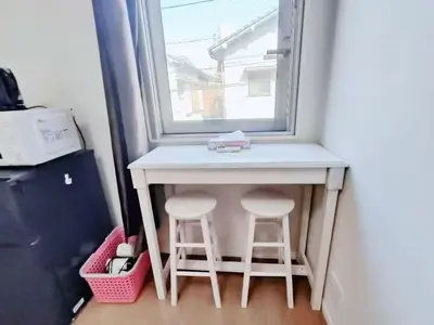 a small table with two stools in front of a window at JR t akadababa subway 5 mins walk! \u9ad8\u7530\u99ac\u5834\u99c5 \u5f92\u6b69\u570f\u5185\u5927\u4eba\u6c17! Shinjuku\u65b0\u5bbf\u5708!\u9ad8\u901f\u65e0\u9650\u5236Wi-FI! AB in Tokyo