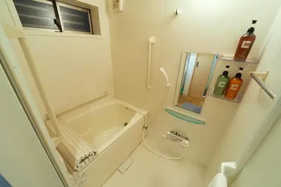 a small bathroom with a tub and a toilet at Shinjuku 'Deep Lane' Villa in Tokyo