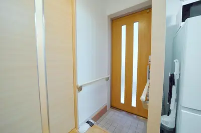a bathroom with a door and a tile floor at Shinjuku 'Deep Lane' Villa in Tokyo