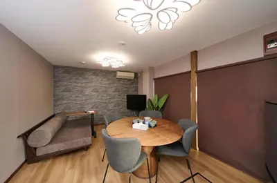 a living room with a table and chairs and a couch at \u30db\u30c6\u30eb\u516b\u5e83 in Tokyo