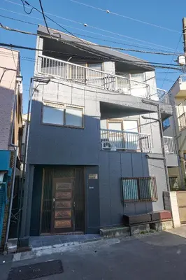 an apartment building with a door and a balcony at \u30db\u30c6\u30eb\u516b\u5e83 in Tokyo