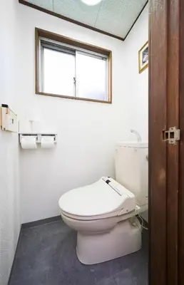 a bathroom with a toilet and a window at \u30db\u30c6\u30eb\u516b\u5e83 in Tokyo