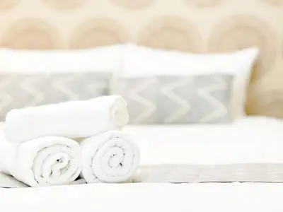 a stack of white towels on a bed at Tokyo Skytree Residence Inn (F2) in Tokyo