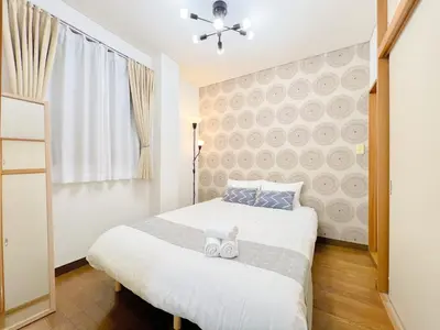 a bedroom with a bed with two teddy bears on it at Tokyo Skytree Residence Inn (F2) in Tokyo