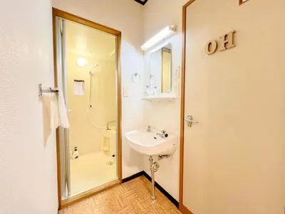 a white bathroom with a sink and a shower at Tokyo Skytree Residence Inn (F2) in Tokyo