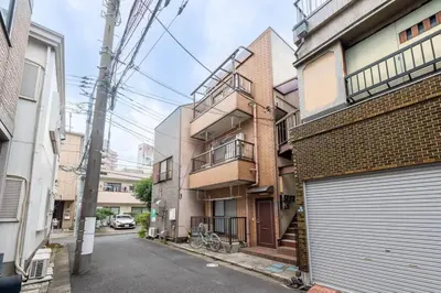 an apartment building with a bike parked on a street at Tokyo Skytree Residence Inn (F2) in Tokyo