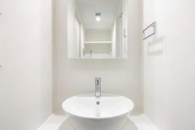 a white bathroom with a sink and a mirror at Lega land\u5e61\u30f6\u8c37 in Tokyo