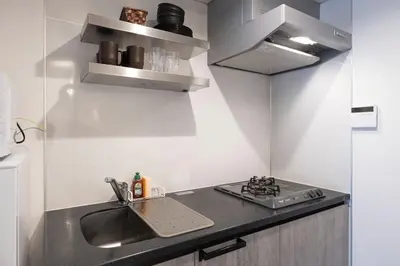 a kitchen with a sink and a stove at Lega land\u5e61\u30f6\u8c37 in Tokyo