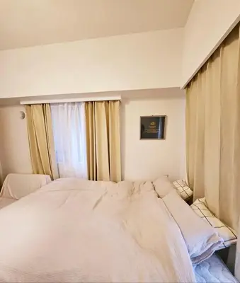 a bedroom with a large bed in front of a window at AsahiStay -Shinjuku, Self check in, Well located house in Tokyo