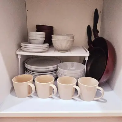 a shelf filled with cups and plates and pans at AsahiStay -Shinjuku, Self check in, Well located house in Tokyo
