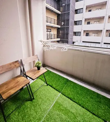 a bench on a balcony with a green lawn at AsahiStay -Shinjuku, Self check in, Well located house in Tokyo