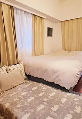 a bedroom with two beds and a window at AsahiStay -Shinjuku, Self check in, Well located house in Tokyo
