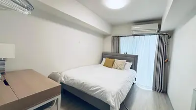 a small bedroom with a bed and a window at Shinjuku 208 in Tokyo