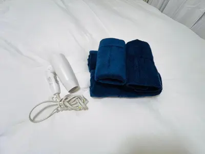 a pair of blue towels on a bed with a keychain at Shinjuku 208 in Tokyo