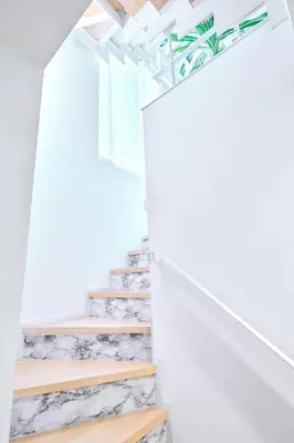 a stairwell with white walls and white stairs with rocks at \u5e83\u3005130\u5e73\u7c73 \u6700\u592713\u540d \u99c5\u5f92\u6b694\u5206 10Gwifi \u591c\u306e\u30d1\u30fc\u30c6\u30a3\u30fc\u3068\u98f2\u307f\u4f1a\u7981\u6b62 in Tokyo