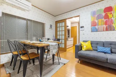 a living room with a table and a couch at KiraKira House Elegant 3BR on Yamanote Line in Tokyo