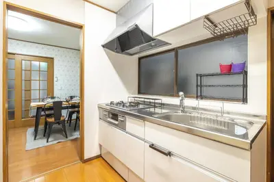 a kitchen with a sink and a table at KiraKira House Elegant 3BR on Yamanote Line in Tokyo