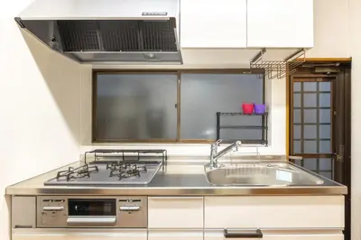 a kitchen with a sink and a stove at KiraKira House Elegant 3BR on Yamanote Line in Tokyo