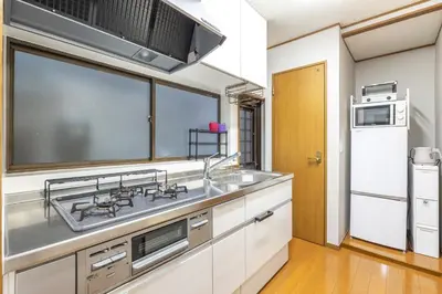 a kitchen with a sink and a microwave at KiraKira House Elegant 3BR on Yamanote Line in Tokyo