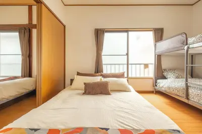 a bedroom with two bunk beds and a large mirror at KiraKira House Elegant 3BR on Yamanote Line in Tokyo