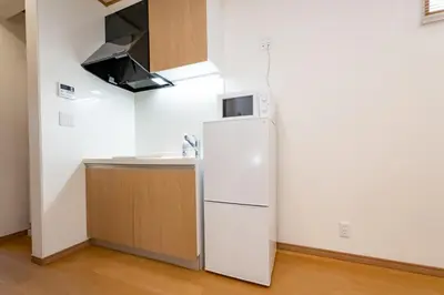 a kitchen with a refrigerator and a sink at Komei Hotel/5min to station/Direct access to Narita and Haneda/Asakusa/Sky tree in Tokyo