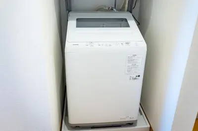 a washer and dryer in a refrigerator at Komei Hotel/5min to station/Direct access to Narita and Haneda/Asakusa/Sky tree in Tokyo