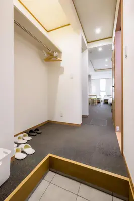 an empty office space with shoes on the floor at Komei Hotel/5min to station/Direct access to Narita and Haneda/Asakusa/Sky tree in Tokyo