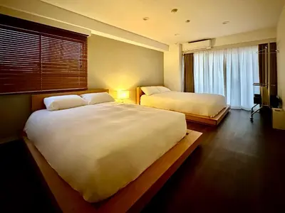 a hotel room with two beds and a window at LoveTokyo Maisonette Terrace in Tokyo