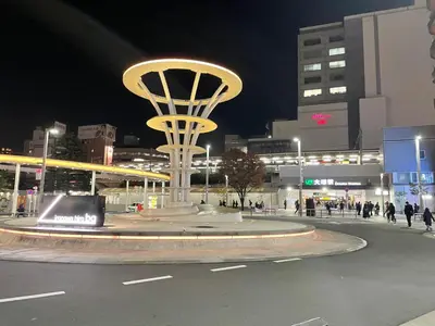 a large clock tower in a city at night at Aurora 3 in Tokyo