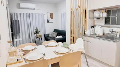 a kitchen and living room with a table and chairs at JW-One in Tokyo