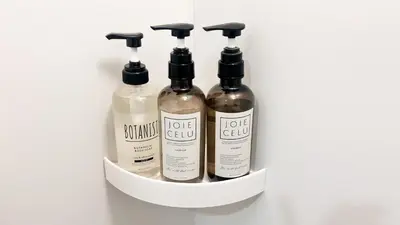 four bottles of shampoo and conditioner in a shelf at JW-One in Tokyo