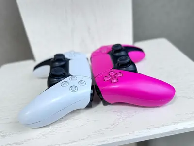 two video game controllers sitting on a table at JW-One in Tokyo