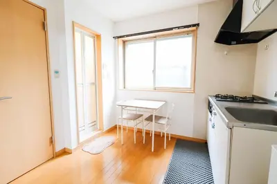 a kitchen with a table and a sink and a window at takadababa 4 mins walk/新宿圈! 高速无限制网路/车站步行4分钟新装修公寓102 in Tokyo