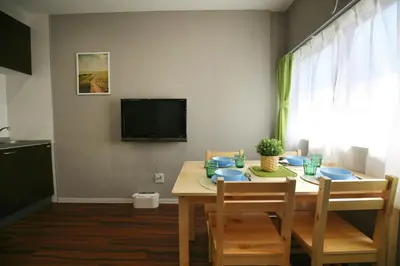 a dining room with a table with chairs and a tv at QU101 Edogawa Japanese Style Apartment 101 has direct access to Akihabara and Shinjuku, with convenient transportation and free WiFi in Tokyo