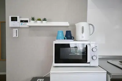 a microwave oven sitting on top of a kitchen counter at QU101 Edogawa Japanese Style Apartment 101 has direct access to Akihabara and Shinjuku, with convenient transportation and free WiFi in Tokyo